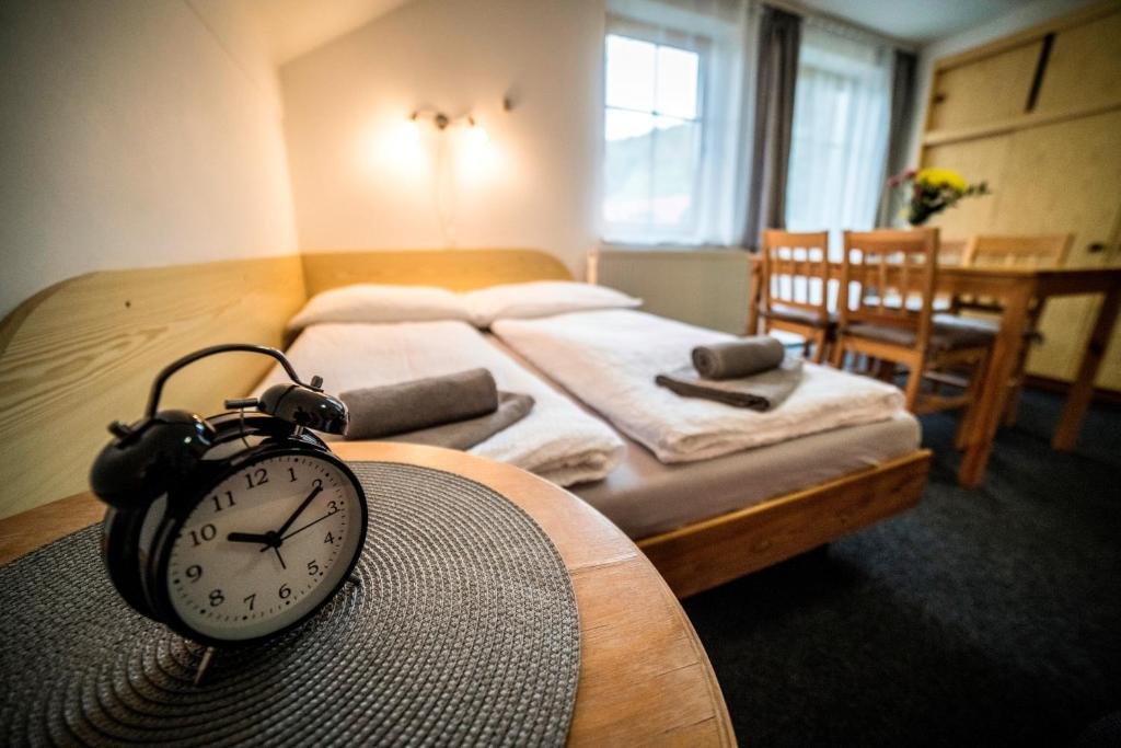 Quadruple Room with Balcony at Pension 222 with two queen beds and seating area