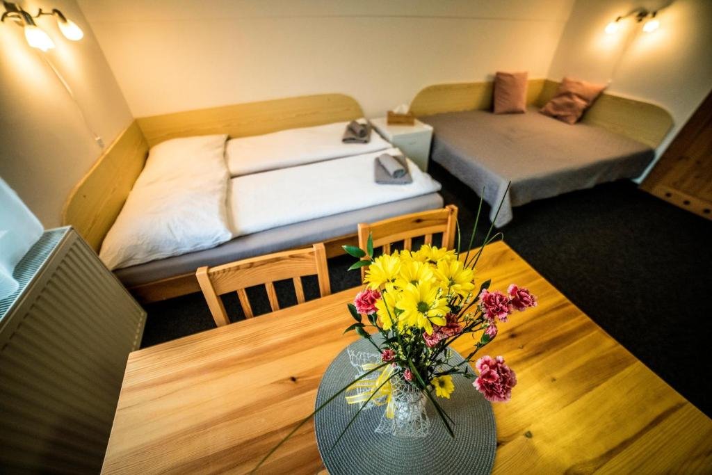 Triple Room with Balcony at Pension 222 with wooden beds and dining table